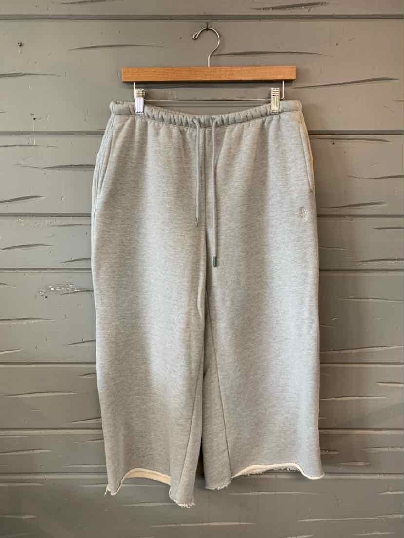 Light gray wide-leg sweatpants with elastic waistband and drawstring, soft cotton blend.