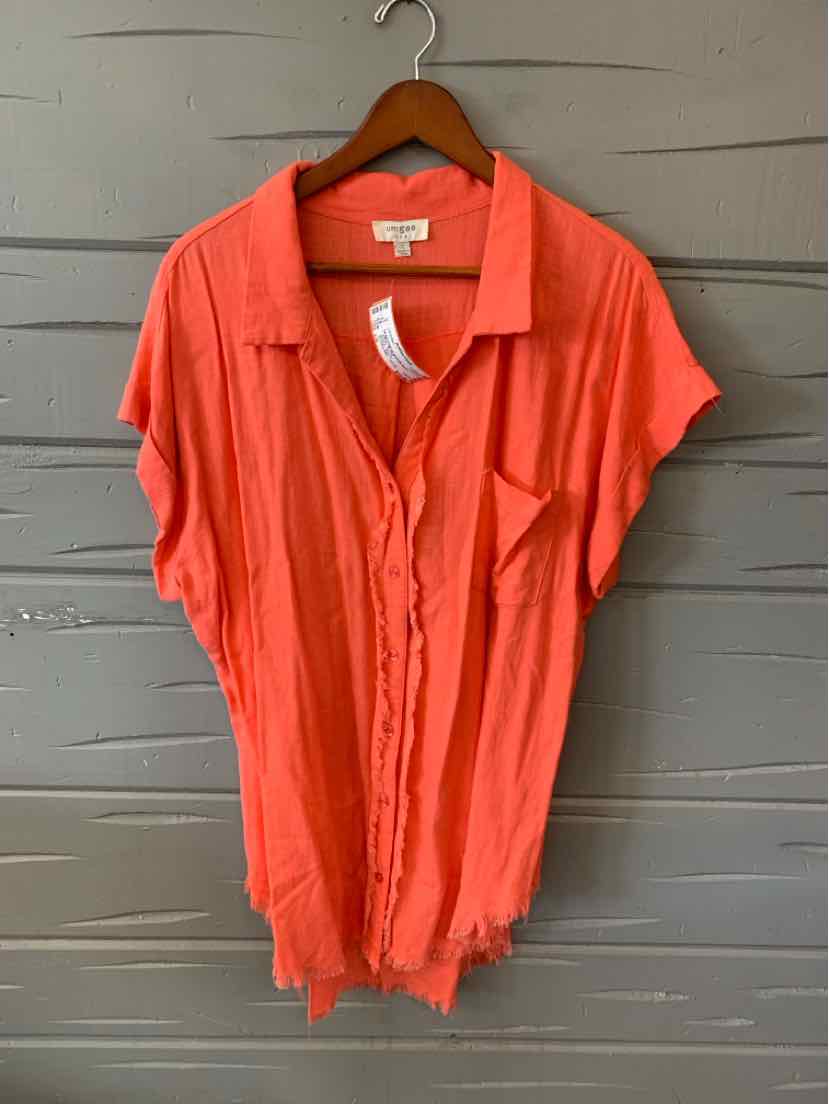 Coral short-sleeve button-up blouse with loose fit and soft fabric on wooden hanger.