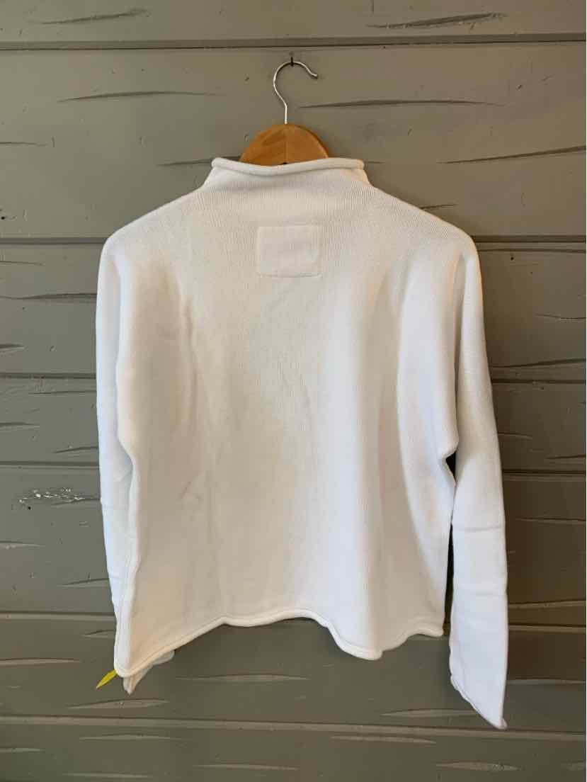 White long-sleeve shirt with a small collar, soft fabric, relaxed fit, hanging on wooden hanger.