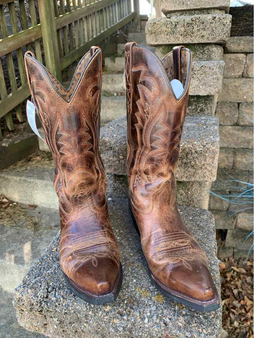 Brown distressed leather western boots with stitched decorative patterns, size 8.