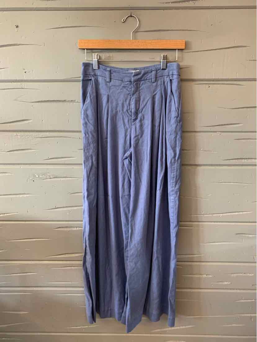High-waisted wide-leg pants in soft blue fabric with belt loops and a front button closure.