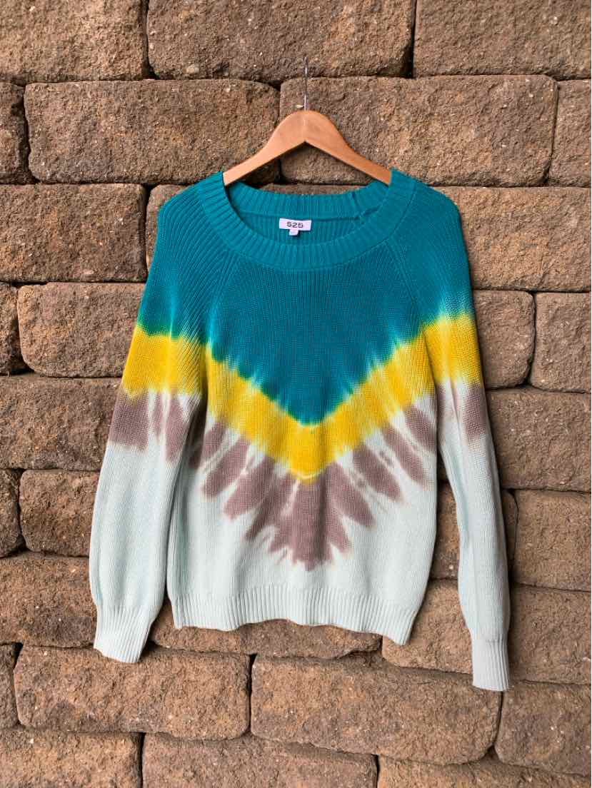 Teal, yellow, brown, and white tie-dyed knit sweater with chevron pattern on wooden hanger.
