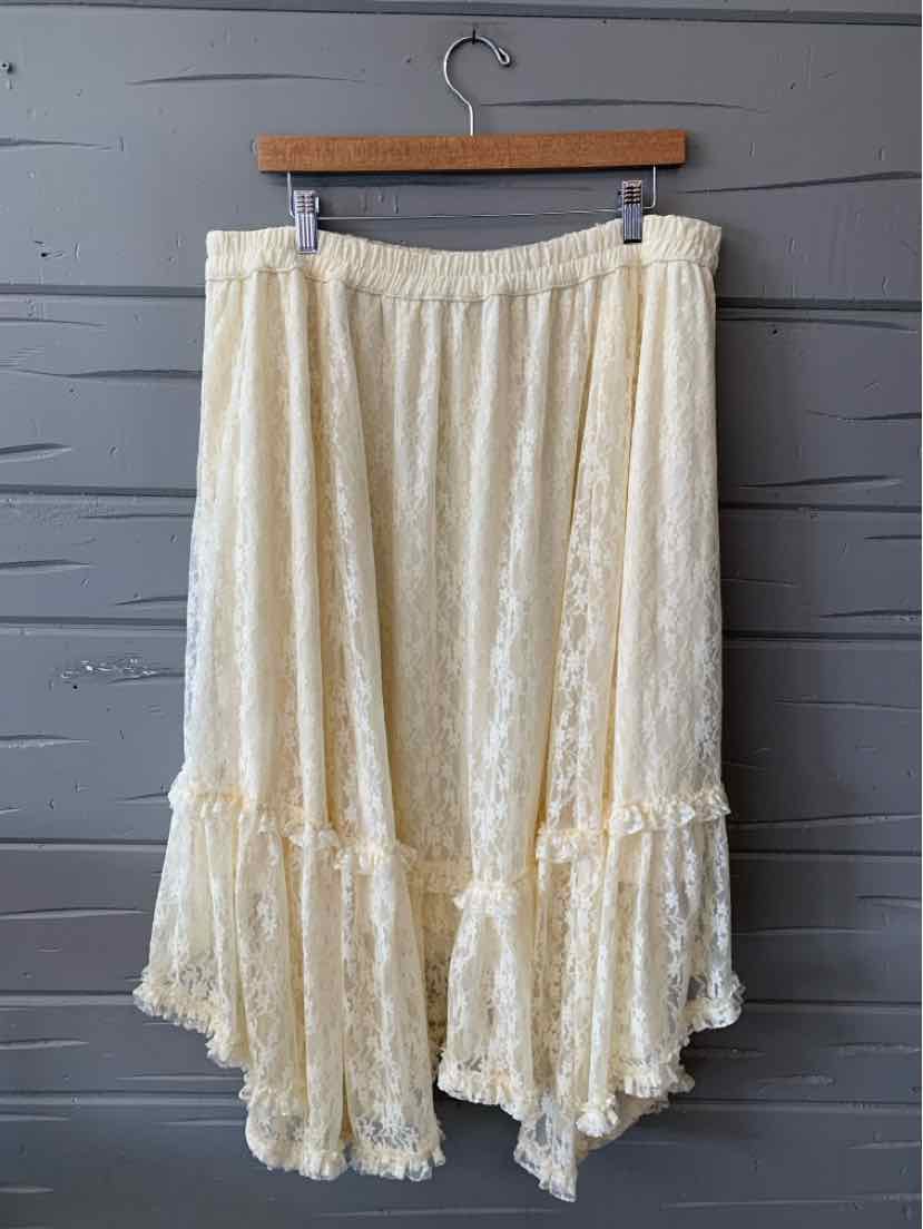 Cream-colored lace skirt with elastic waistband and asymmetrical ruffled hem in size XL.