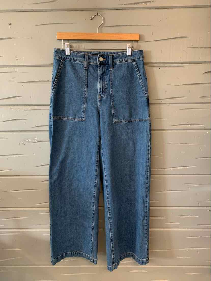 High-waisted blue denim jeans with wide legs and front patch pockets.