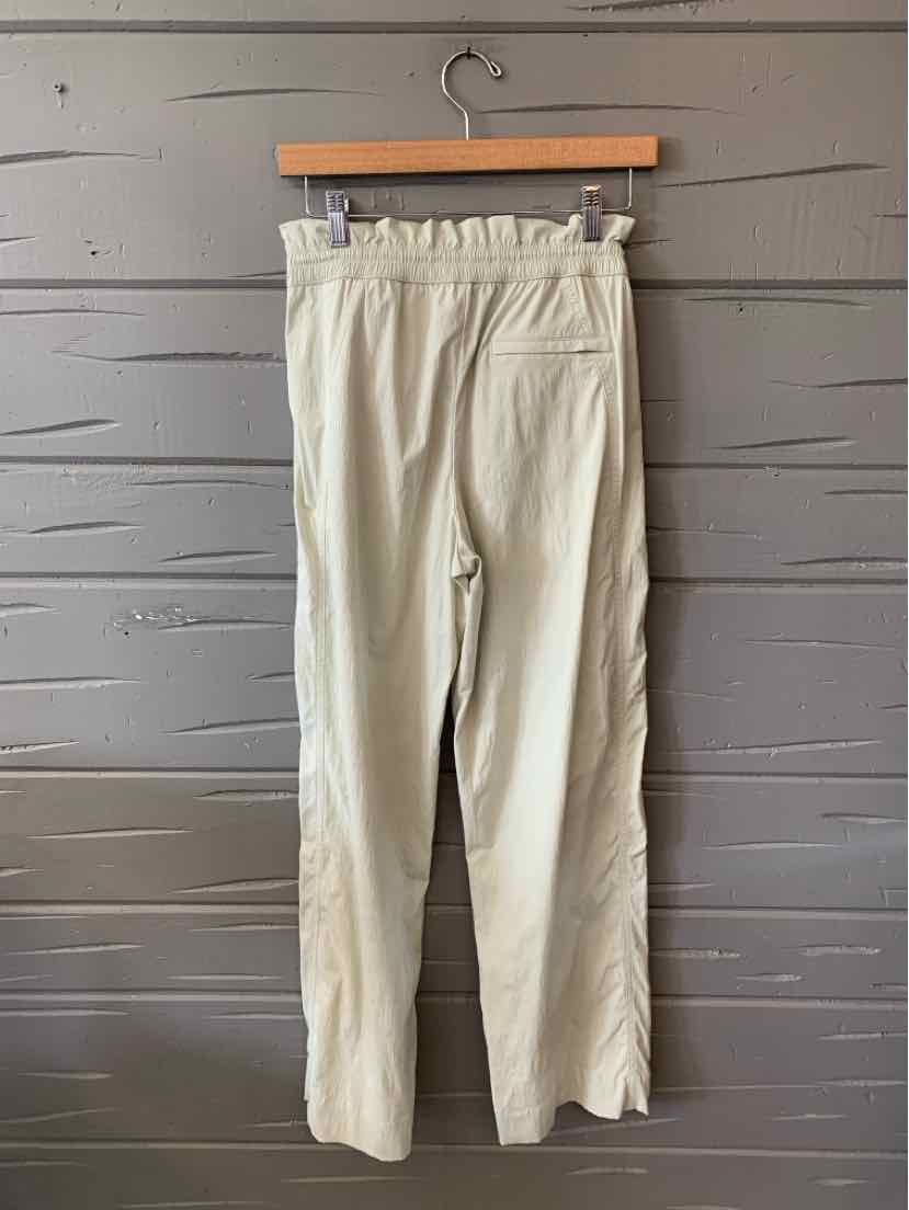 Light mint green pants with an elastic ruched waistband and straight legs, made from soft fabric.