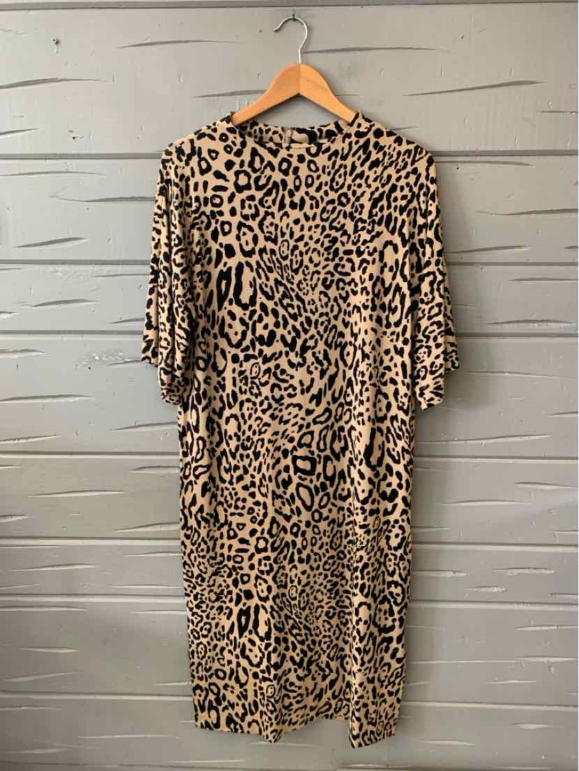 Tan leopard print midi dress with short sleeves and a round neckline hanging on wooden hanger.