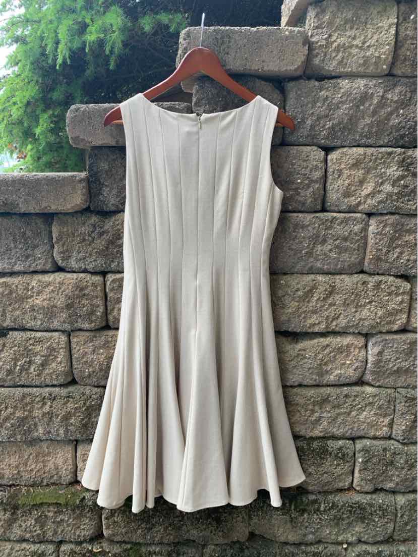 Beige sleeveless Calvin Klein dress with pleated detailing and flared skirt size 4.