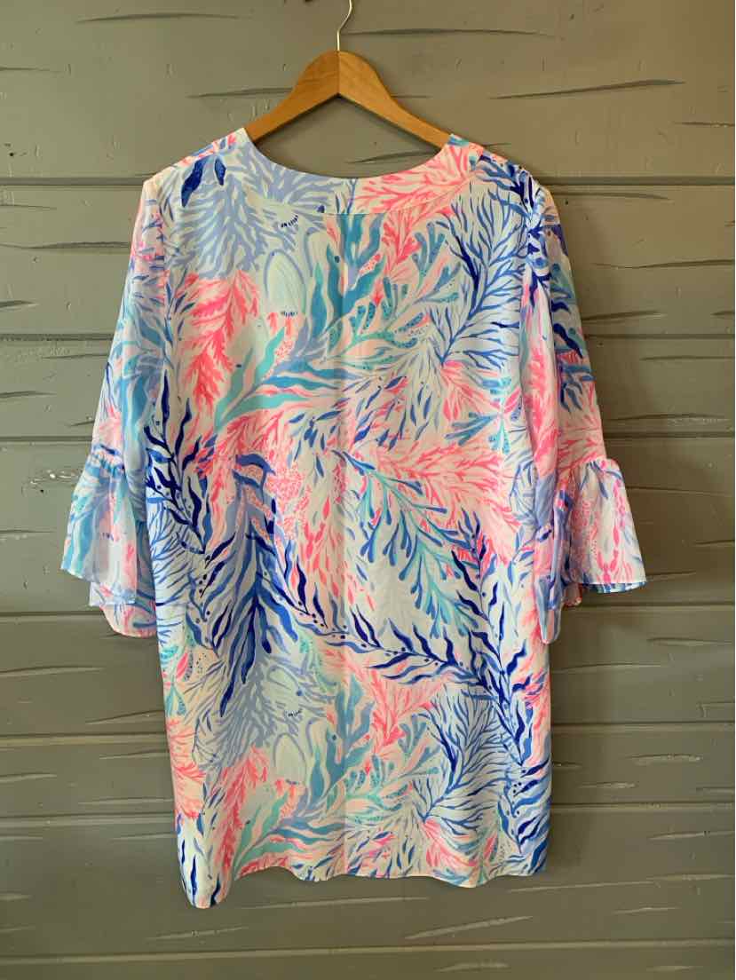 Colorful long-sleeve dress with pink, blue, and coral leaf print, bell sleeves, and round neckline.
