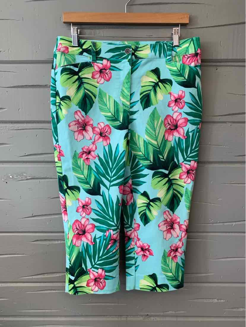 Tropical print Capri pants with green leaves and pink flowers on light blue background.