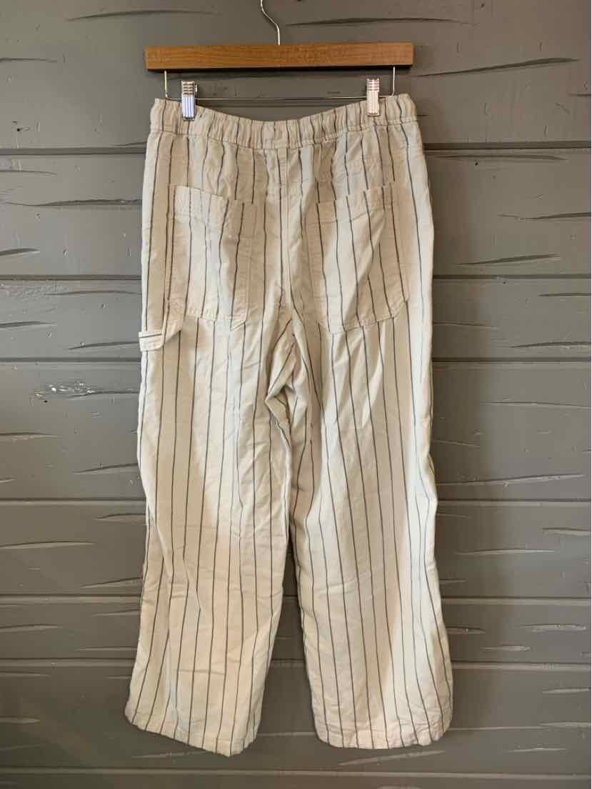 Beige lightweight pants with vertical black stripes, elastic waistband, and relaxed fit.