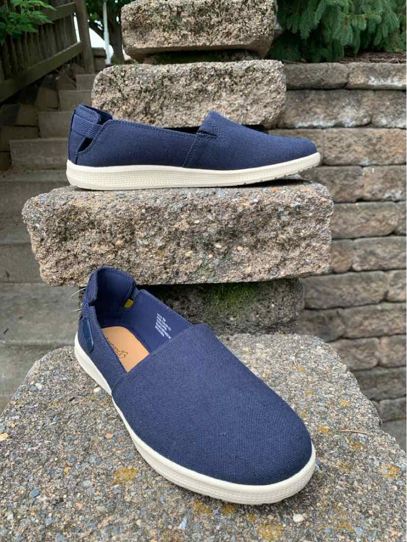 Navy blue casual slip-on shoe with white rubber sole and fabric upper.
