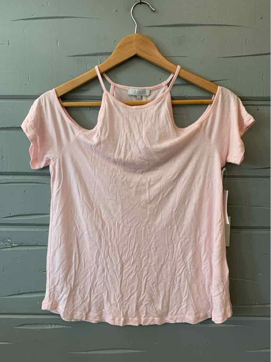 Light pink short-sleeve cold shoulder top with scoop neckline on wooden hanger.