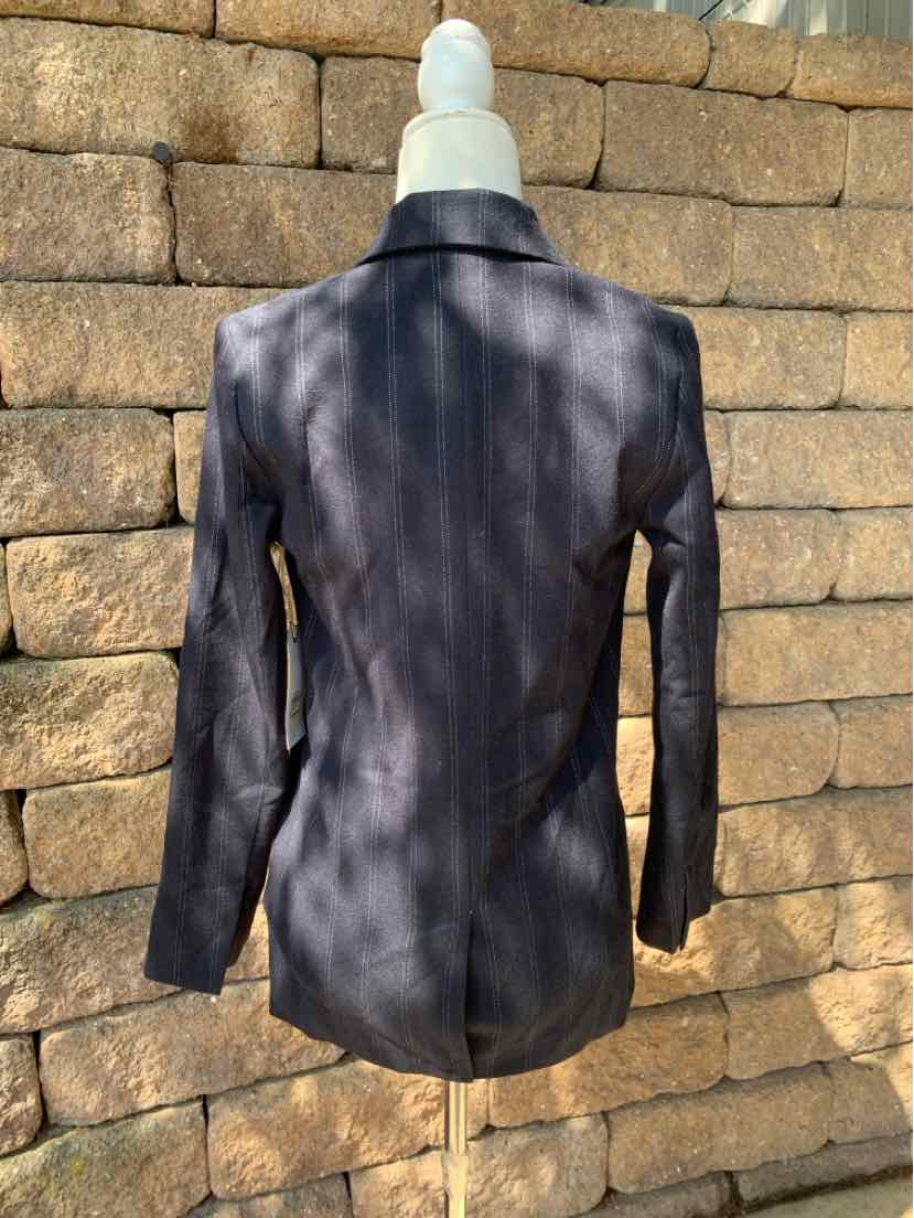 Black tailored blazer with long sleeves and structured shoulders on mannequin, shown from back.