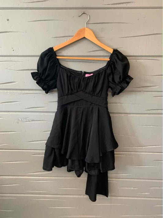 Black short dress with puffed sleeves, square neckline, and layered asymmetrical hem.