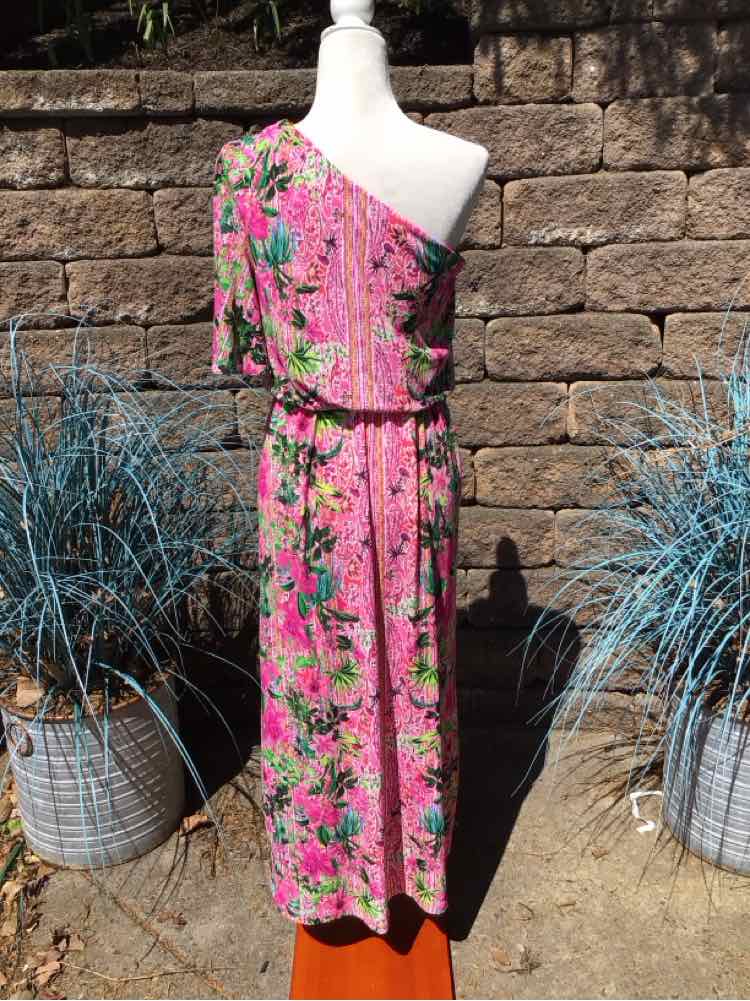 Pink floral one-shoulder midi dress with green and black leaf print on a mannequin outdoors.