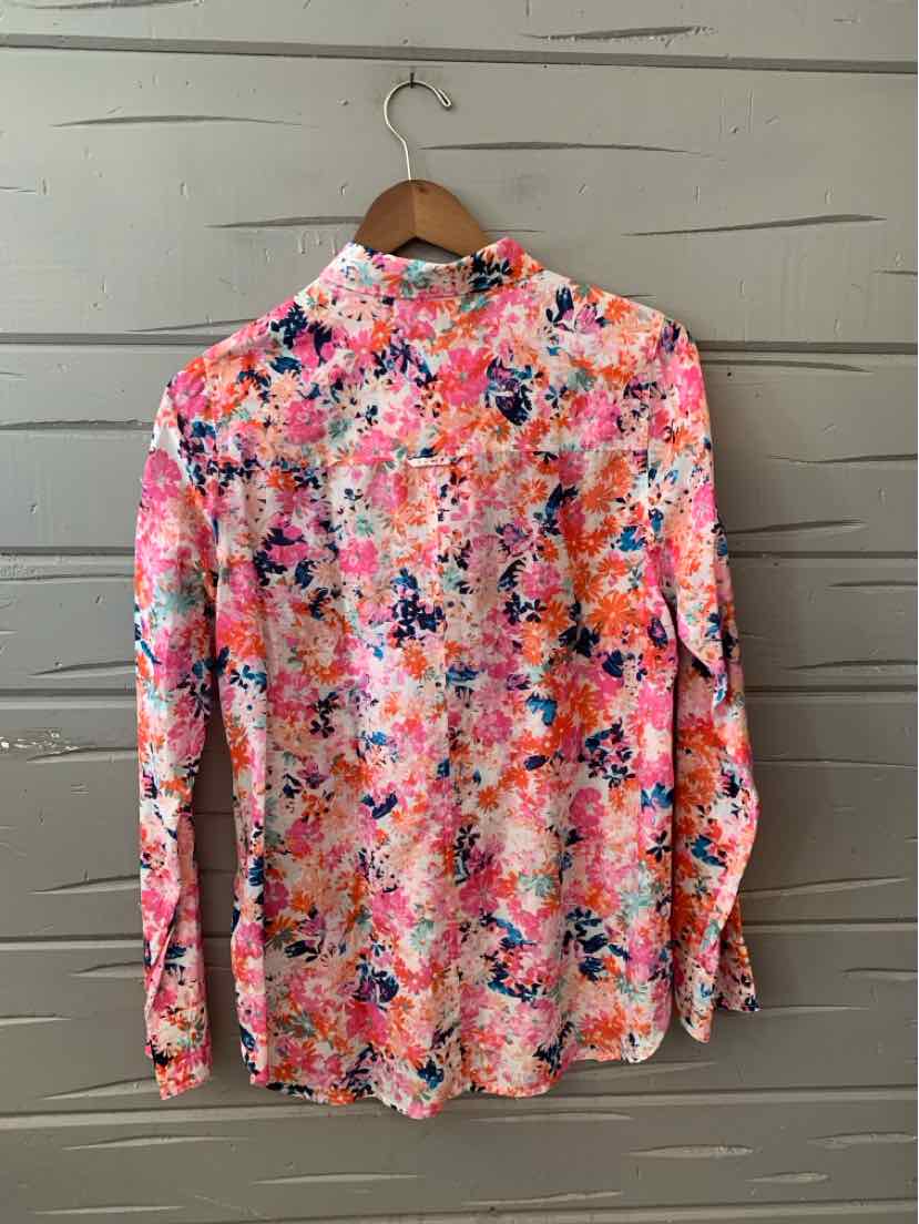Long-sleeve floral blouse with bright pink, orange, blue, and white colors on lightweight fabric.