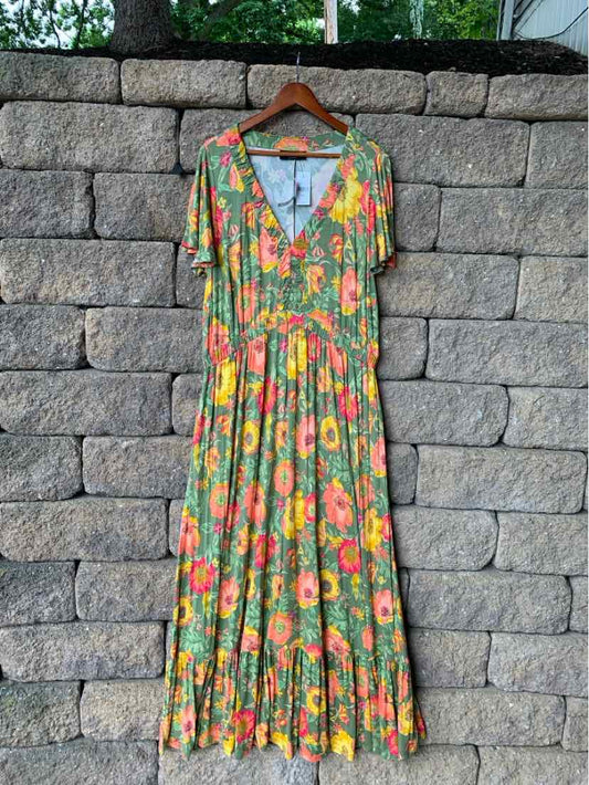 Green floral maxi dress with short sleeves and V-neckline, gathered waist detail.