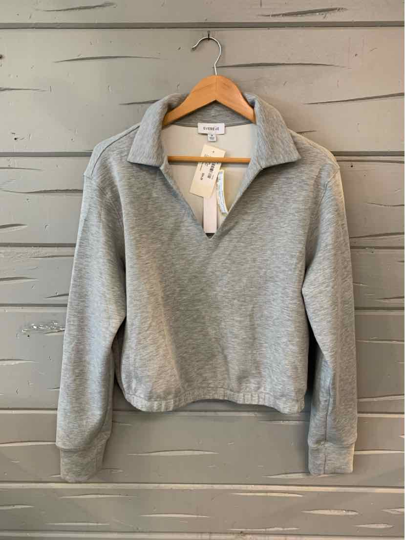 Heather gray quarter-zip pullover sweatshirt with long sleeves and a relaxed fit on wooden hanger.