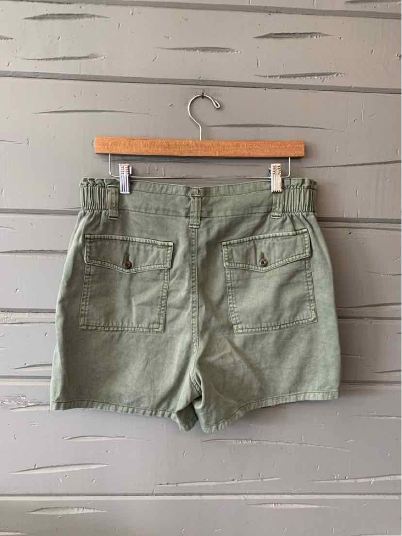 Olive green high-waisted shorts with elastic waistband and two back flap pockets.