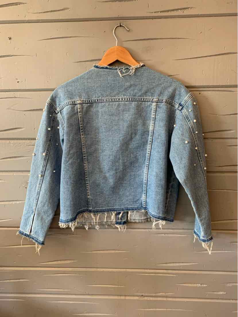 Light blue cropped denim jacket with pearl embellishments on sleeves and raw hem edges.