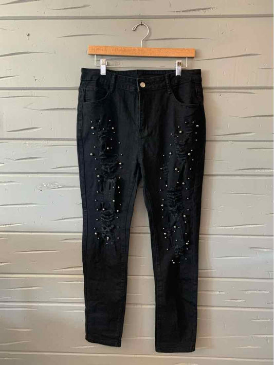 Black denim jeans with distressed details and stud embellishments, slim fit, size XL.