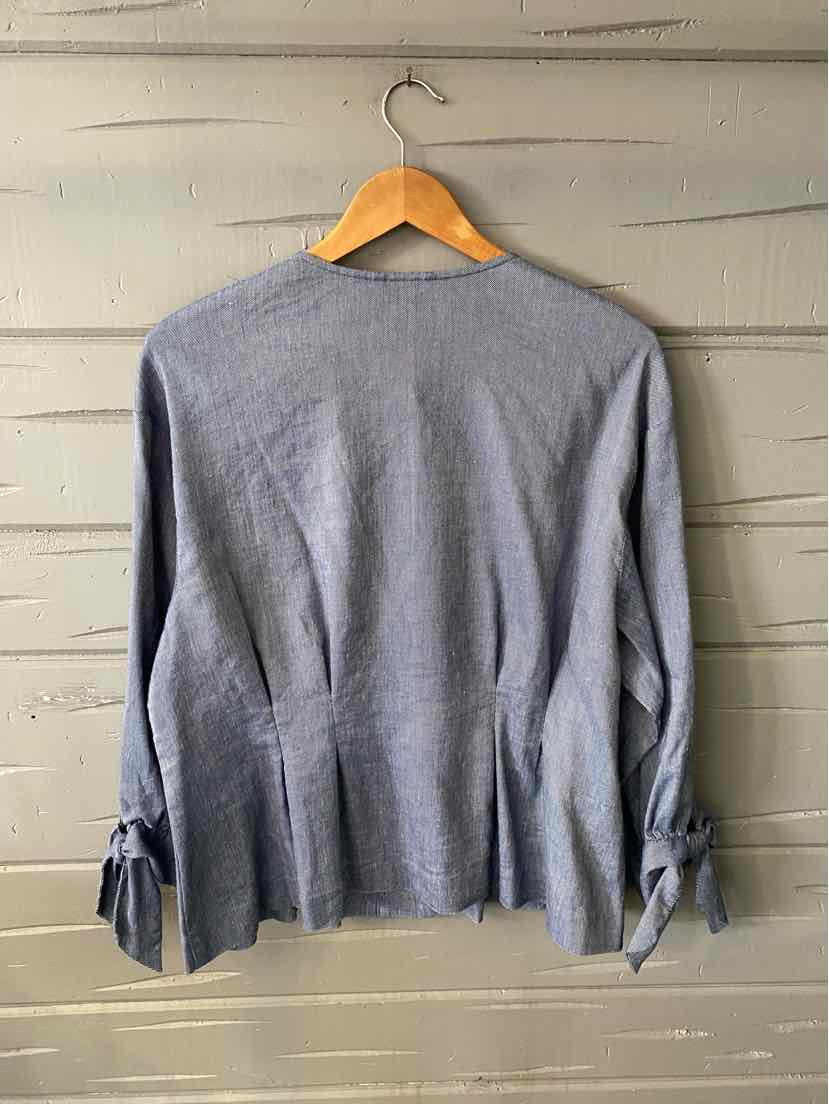 Light blue long-sleeve top with tie details on sleeves and a slightly flared hem, size XL.