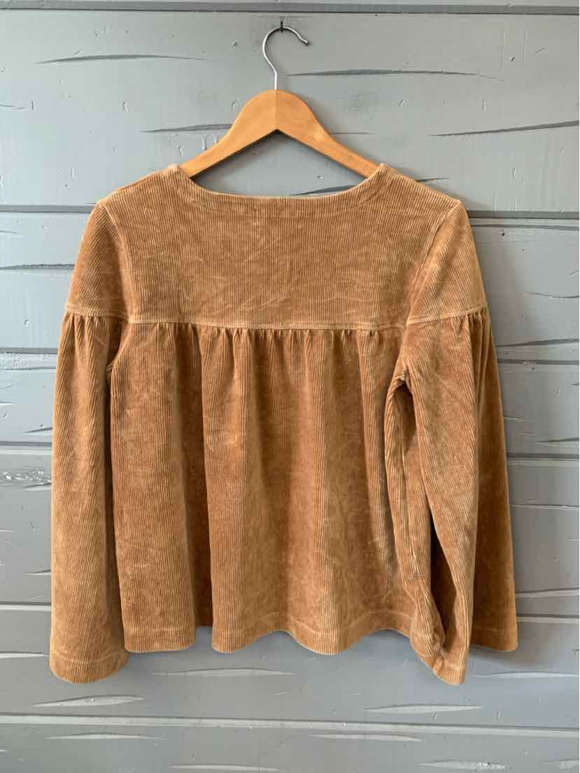 Tan long-sleeve textured corduroy blouse with gathered back yoke and loose fit on wooden hanger.