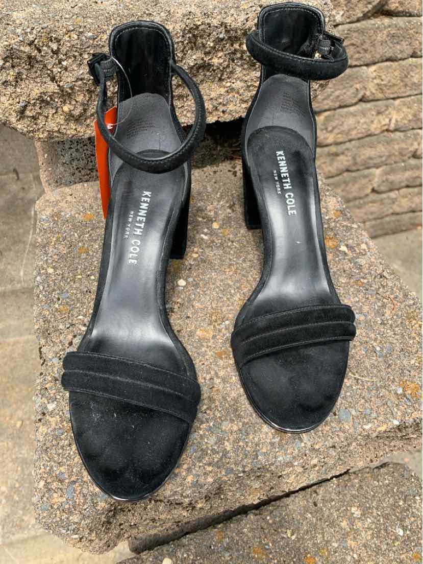 Black suede open-toe ankle-strap high heel sandals with thin heels and padded footbed.