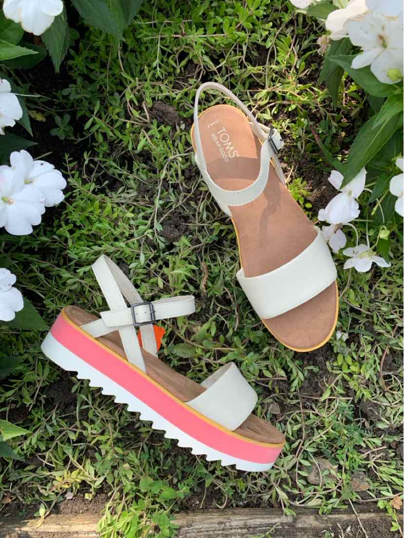 White leather women's sandals with adjustable ankle strap and pink, white, and coral layered platform sole.