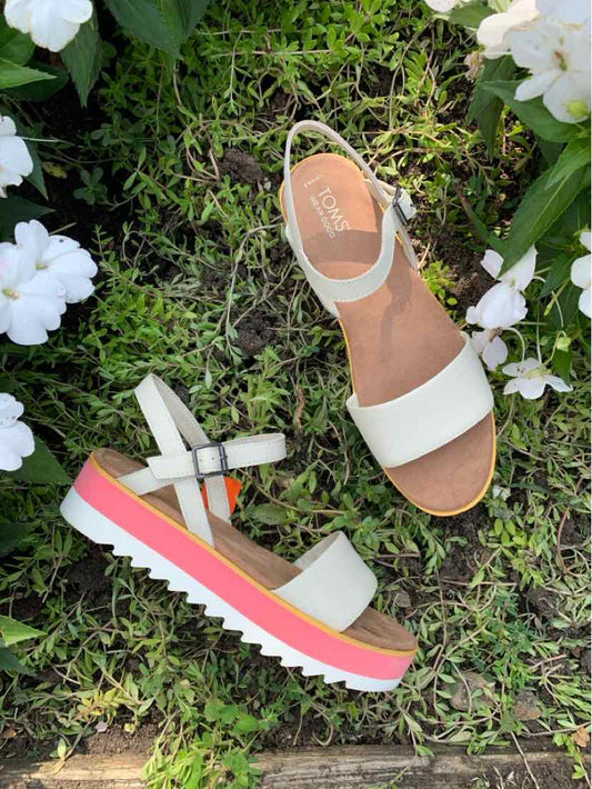 White leather women's sandals with adjustable ankle strap and pink, white, and coral layered platform sole.
