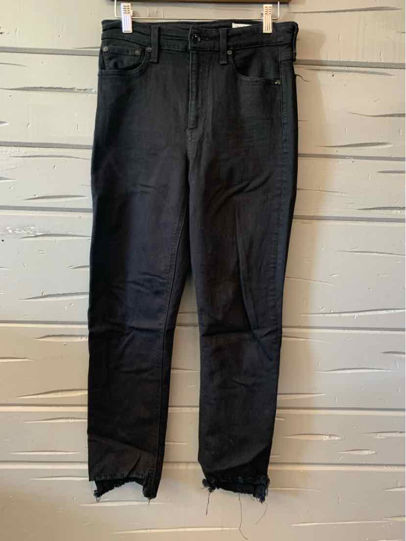 Black denim jeans with high waist and frayed hems, styled for women's casual and activewear looks.