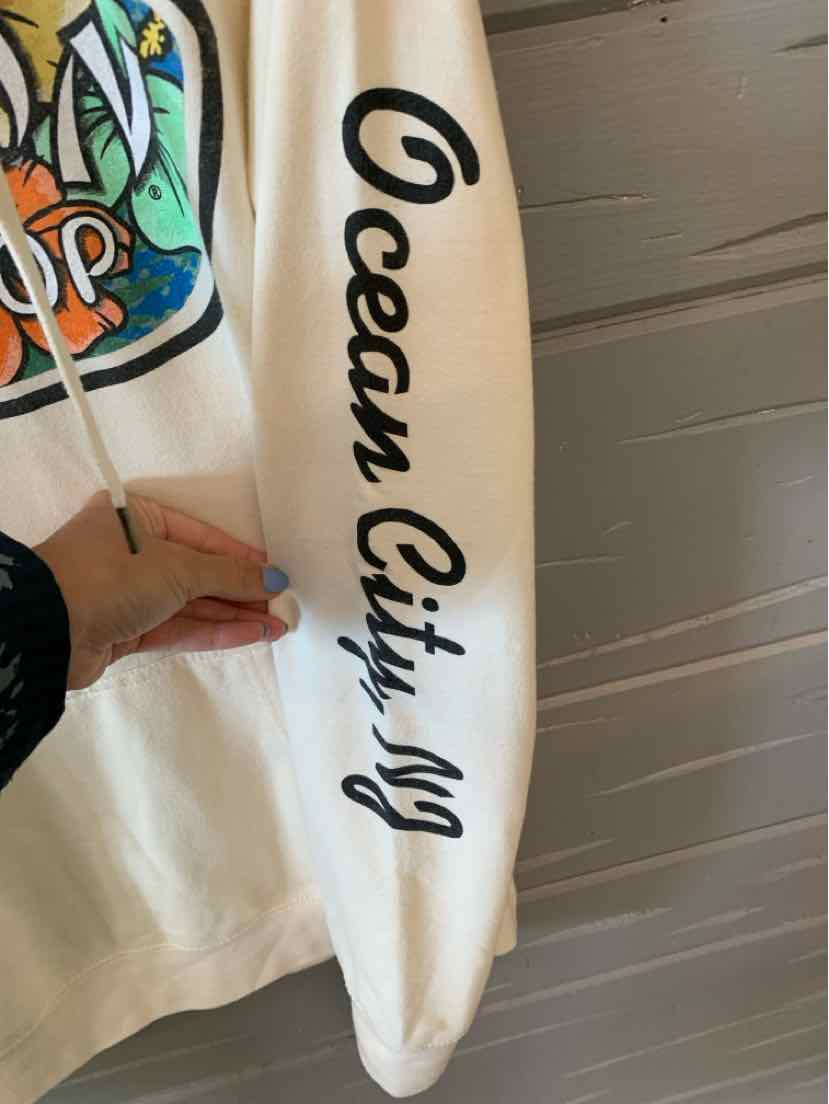 White long-sleeve shirt sleeve with black cursive "Ocean City NJ" text printed vertically.
