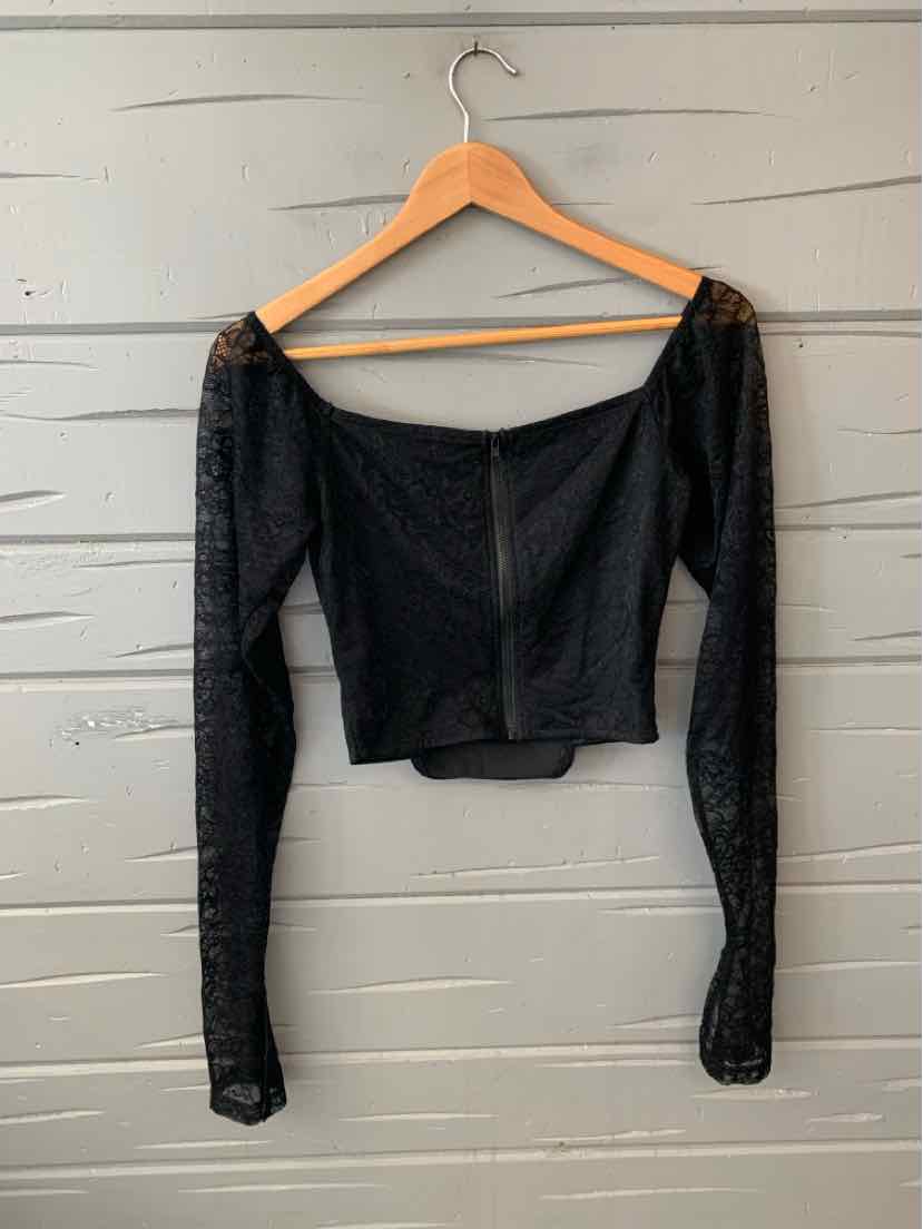 Black lace long-sleeve crop top with square neckline and fitted bodice on wooden hanger.