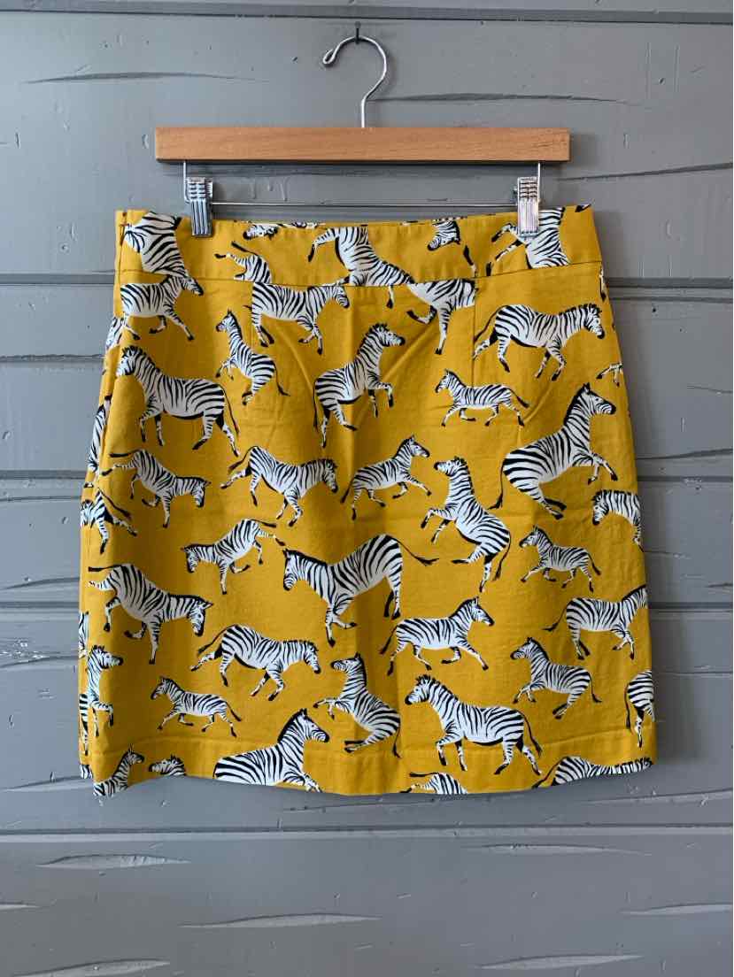 Yellow A-line skirt with black and white zebra print, mid-thigh length, belt loops.