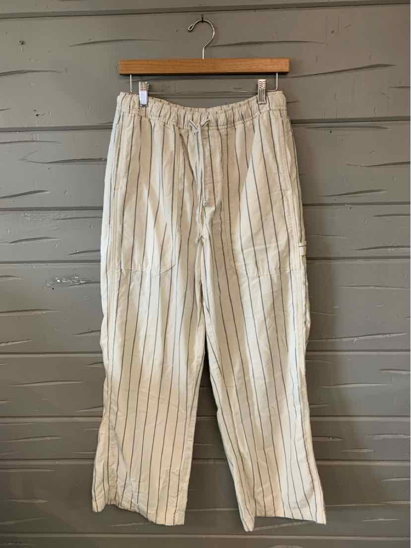 White lightweight pants with vertical thin black stripes and an elastic waistband, relaxed fit.
