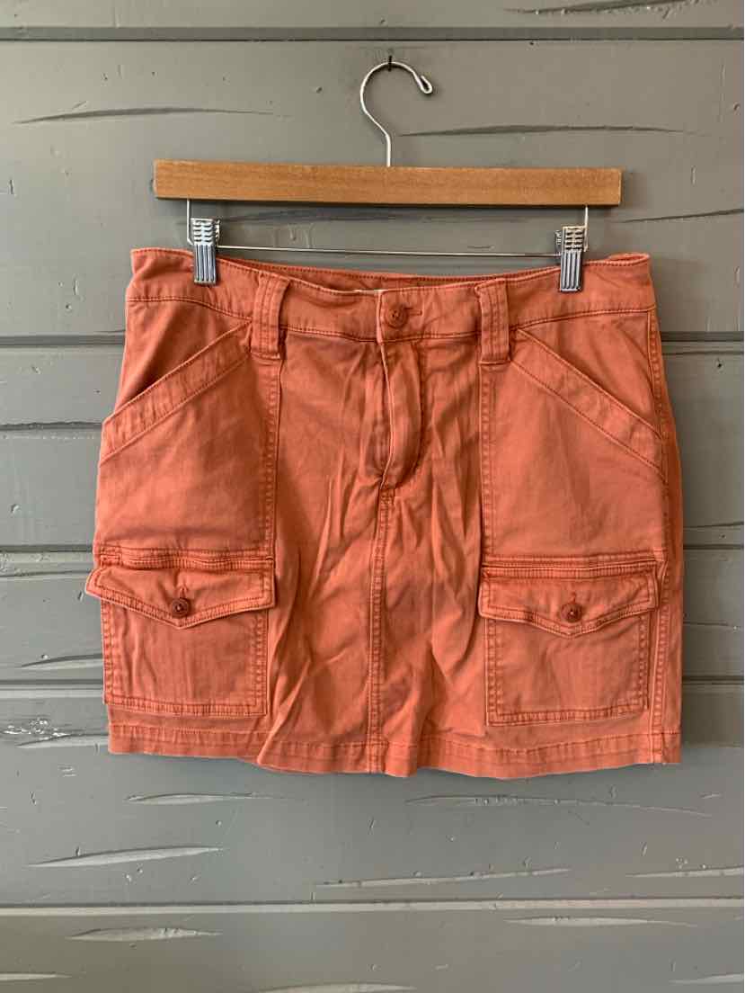 Rust-colored cotton cargo shorts with front flap pockets and belt loops, size 10.