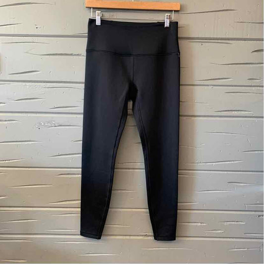 Black high-waist activewear leggings for women, perfect for casual tops and fashion sneakers styling.