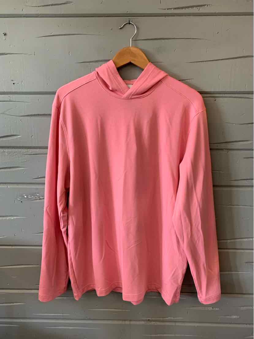 Solid pink long-sleeve pullover with a small collar and relaxed fit hanging on wooden hanger.
