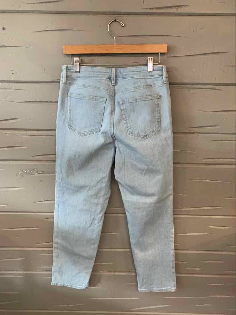 Light blue denim jeans with a relaxed fit, back pockets, and a slightly cropped hem hanging on a wooden hanger.