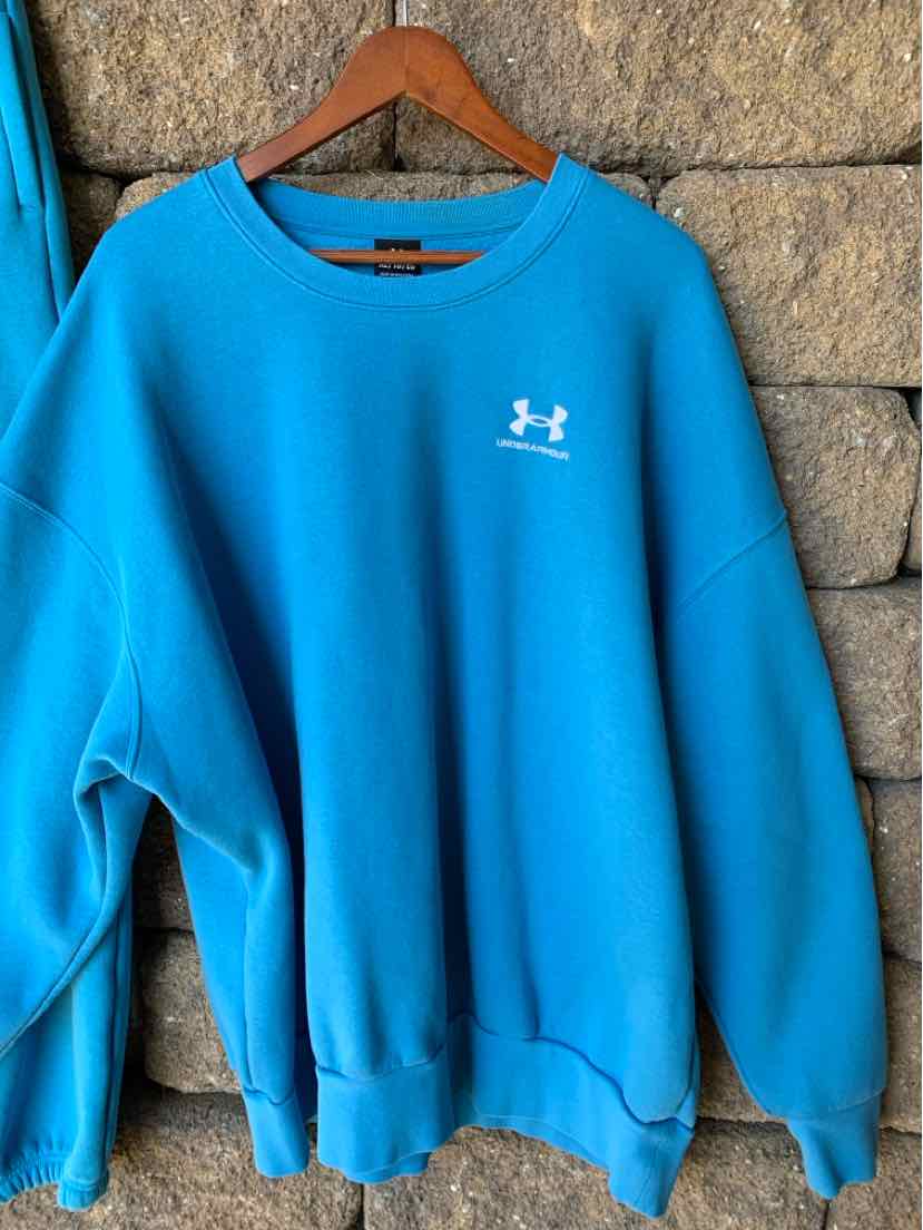 Bright blue Under Armour crewneck sweatshirt with a small white chest logo and ribbed cuffs and hem.