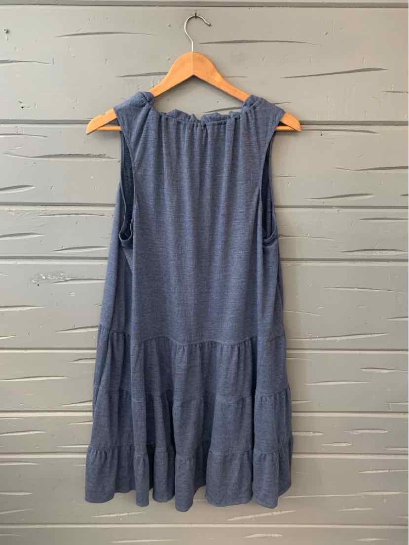 Sleeveless navy blue maxi dress with tiered skirt and gathered neckline hanging on wooden hanger.