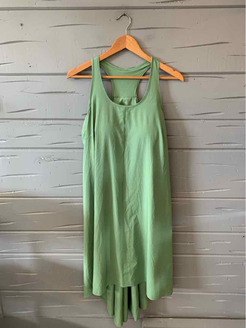 Sleeveless green maxi dress with scoop neckline and flowy fabric hanging on wooden hanger.
