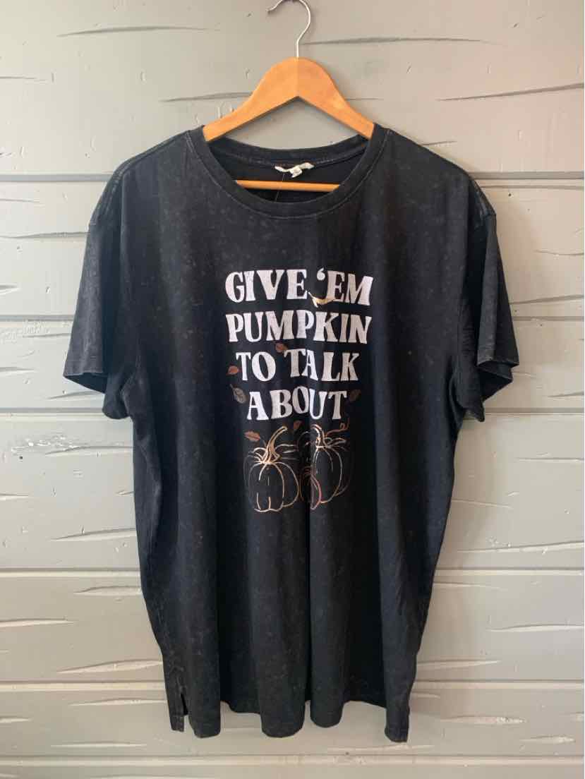 Black oversized short-sleeve T-shirt with white and orange text and pumpkin graphic on front.