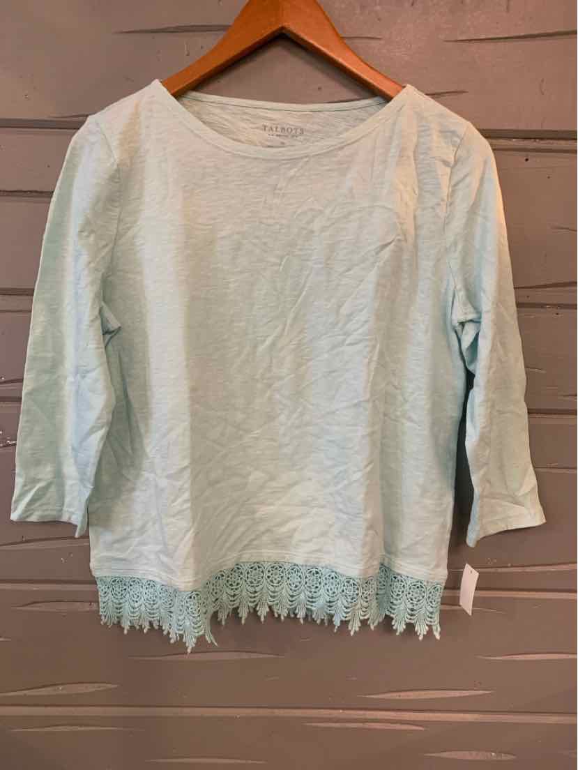 Light aqua long-sleeve top with round neckline and lace trim hem hanging on wooden hanger.