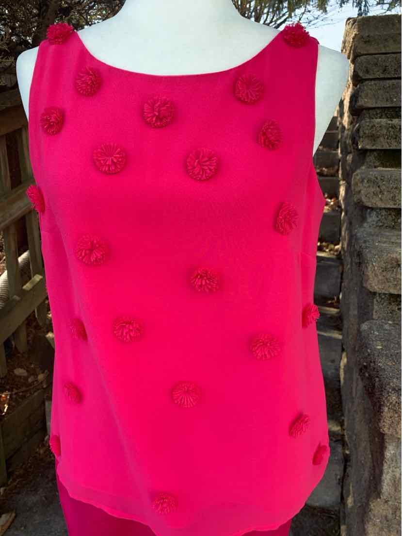 Sleeveless bright pink top with round neckline and textured floral appliqués all over.