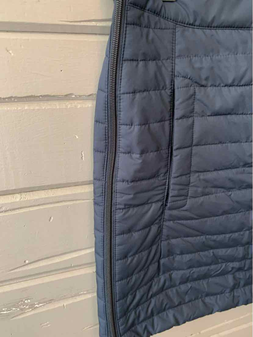 Black quilted jacket with horizontal stitching and side zipper pocket detailing.