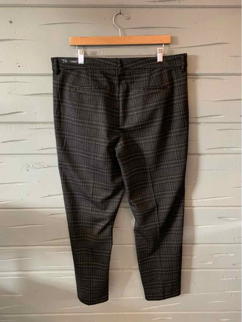 Dark gray slim-fit pants with subtle plaid pattern and flat front, size 14, hanging on wooden hanger.