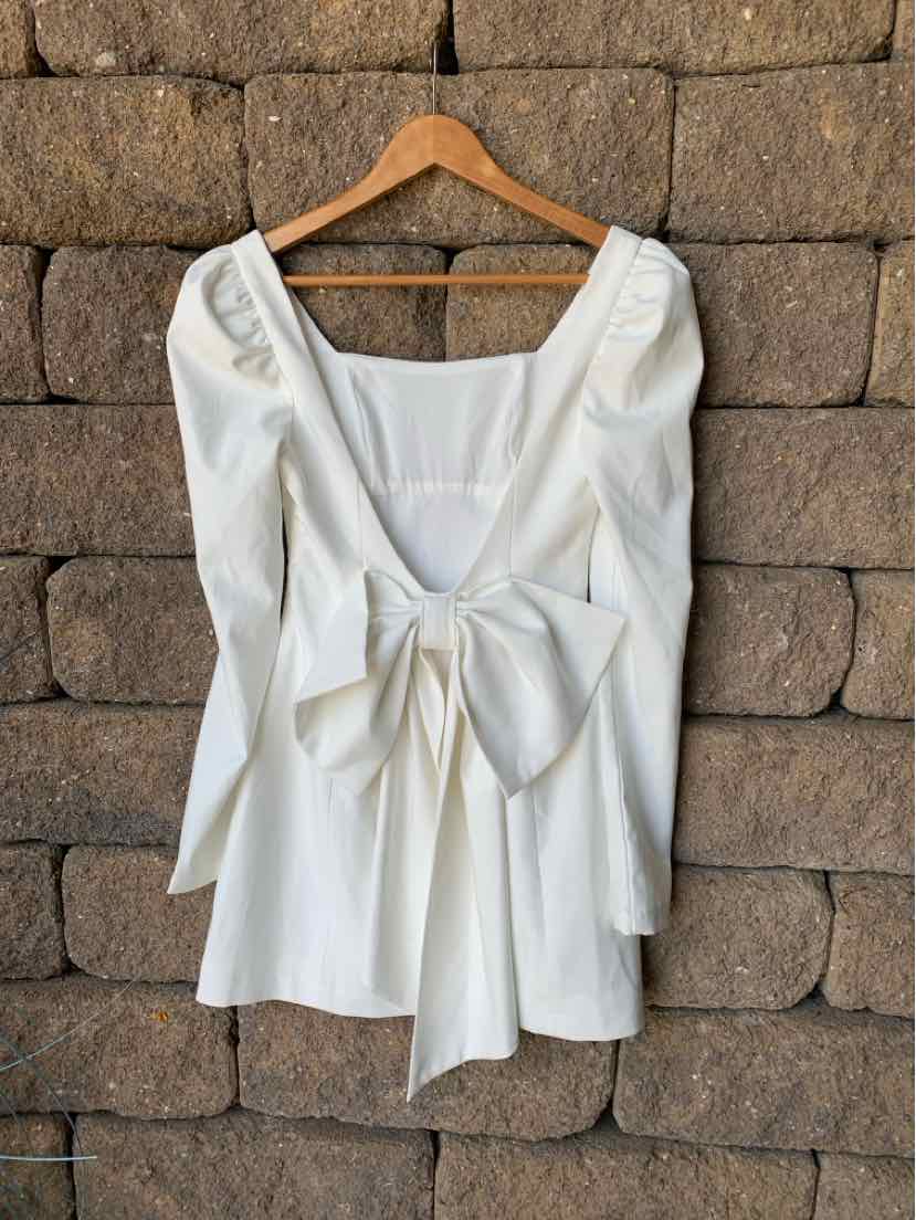 White long-sleeve dress with square neckline and large front bow detail in XS size.
