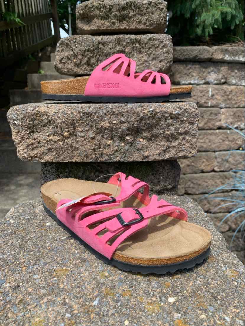 Pink Birkenstock sandal with multiple cut-out straps and adjustable buckles, cork footbed, black outsole.