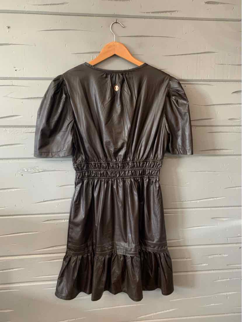 Black faux leather dress with puff sleeves, cinched waist, and ruffled hem.